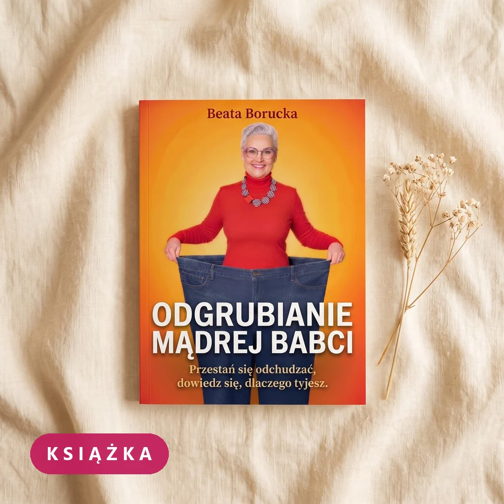 Książka papierowa „Odgrubianie Mądrej Babci” leżąca na lnianej tkaninie